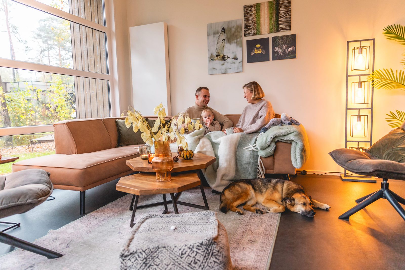 family with kid and dog in holiday home cosy
