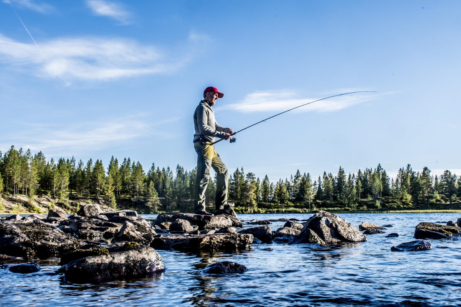 Man standing on rock fishing