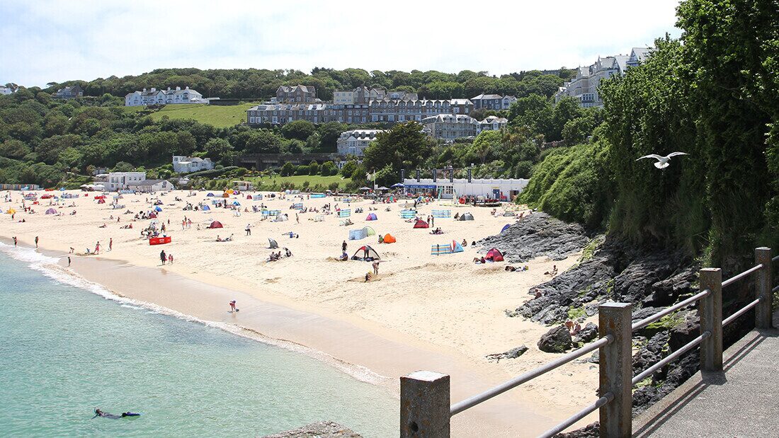 Holidaymakers on Fistral Beach near Newquay in Cornwall