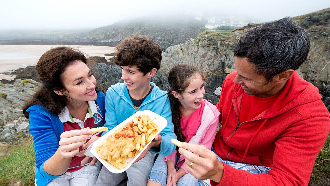Family enjoying fish and smiling