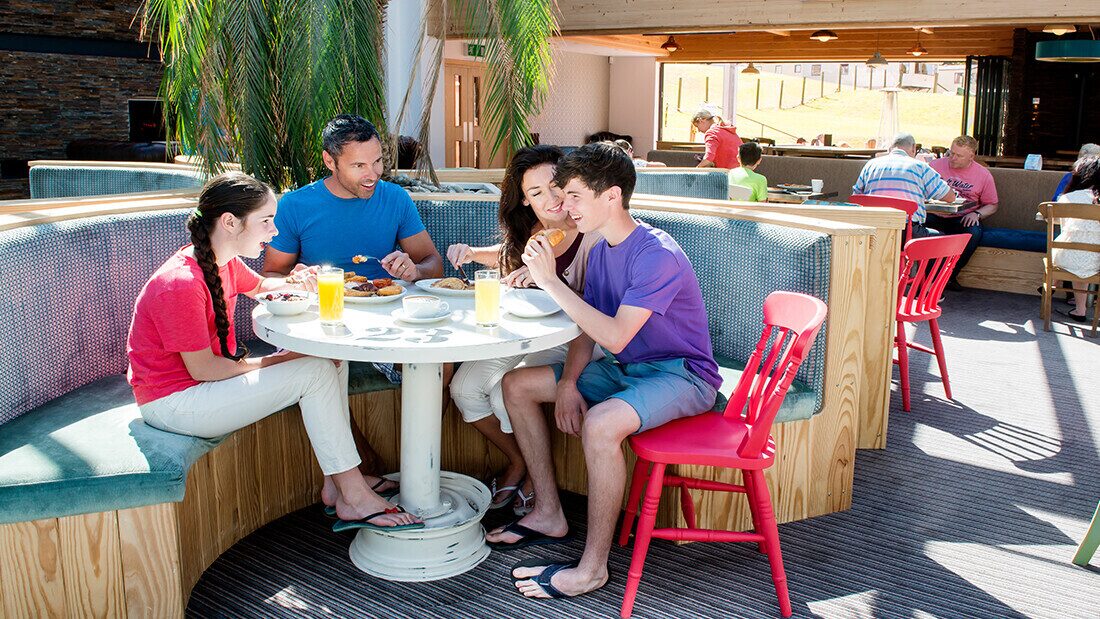 Family breakfast at bar 51 Family enjoying a cooked breakfast together at a bright, modern restaurant with booth seating and natural light.