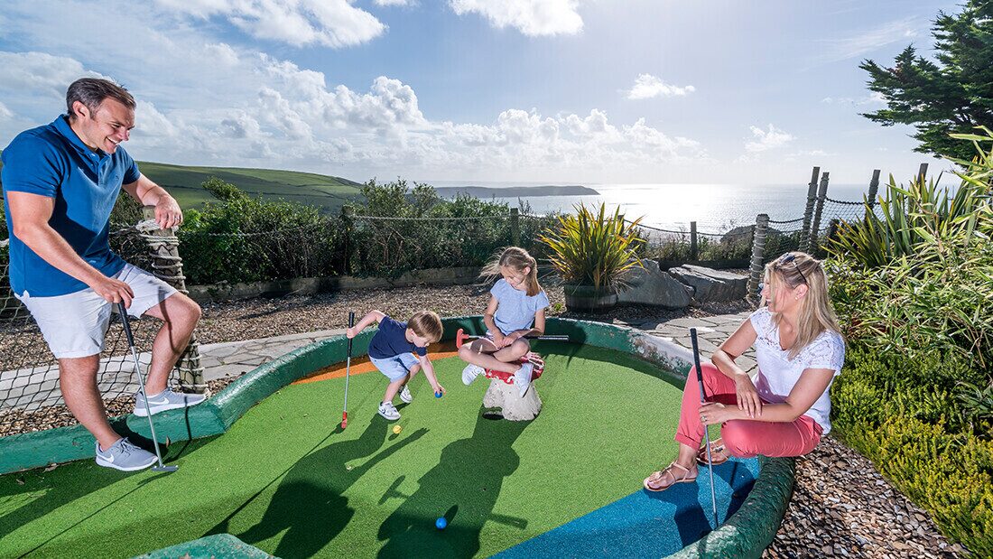 Adventure golf course at Woolacombe Bay Holiday Park Family enjoying a game of crazy golf at Woolacombe Bay Holiday Park with stunning sea views in Devon