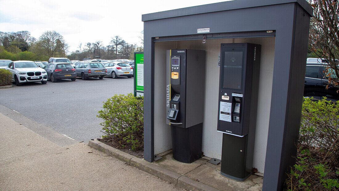 Budget hotels often car for car parking, even in remote locations Car park payment machines at a budget hotel parking lot with cars in the background