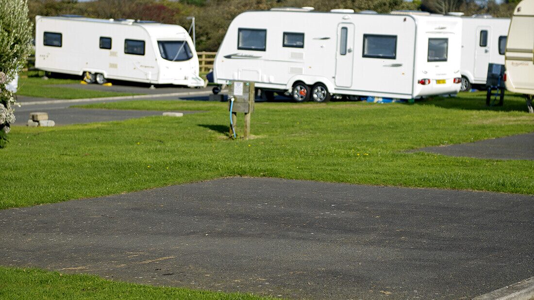 Spacious hardstanding electric pitches at Twitchen House – ideal for caravans and motorhomes