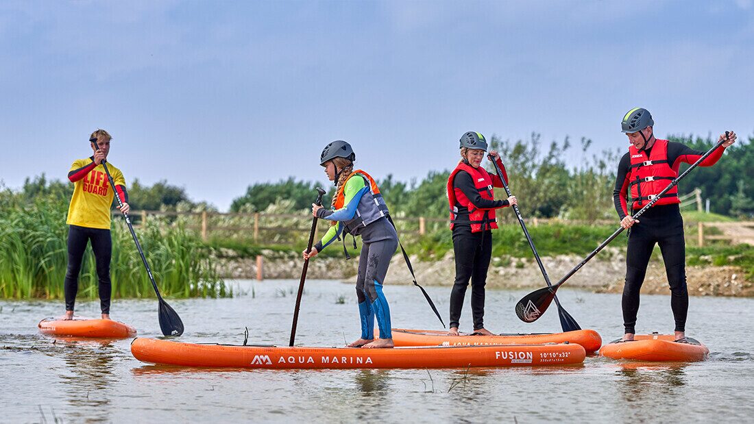 Enjoy paddleboarding lessons with expert instructors on the watersports lake at Woolacombe Bay Holiday Park