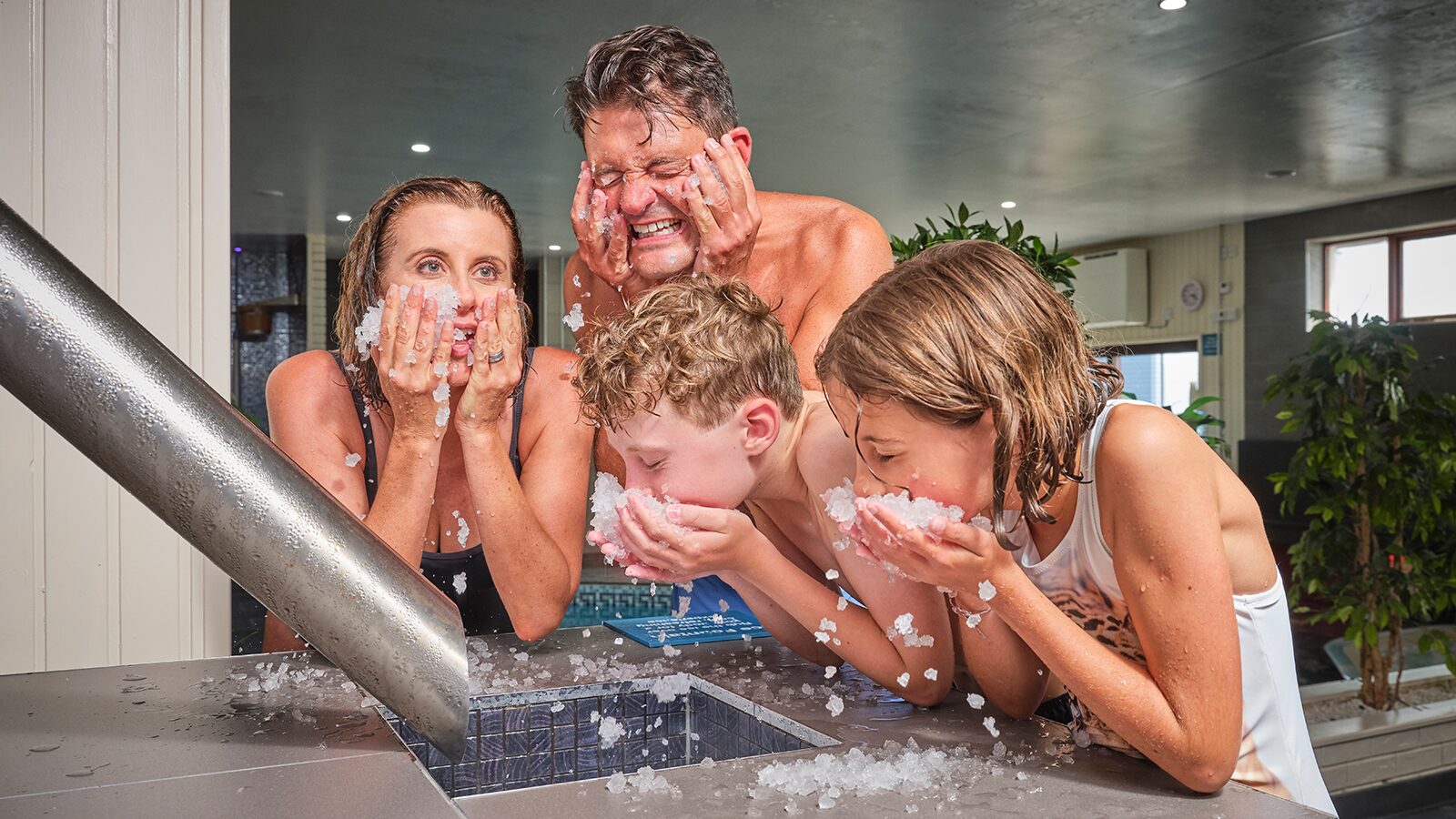 four family members covering their ice at the spa fountain at Woolacombe Bay