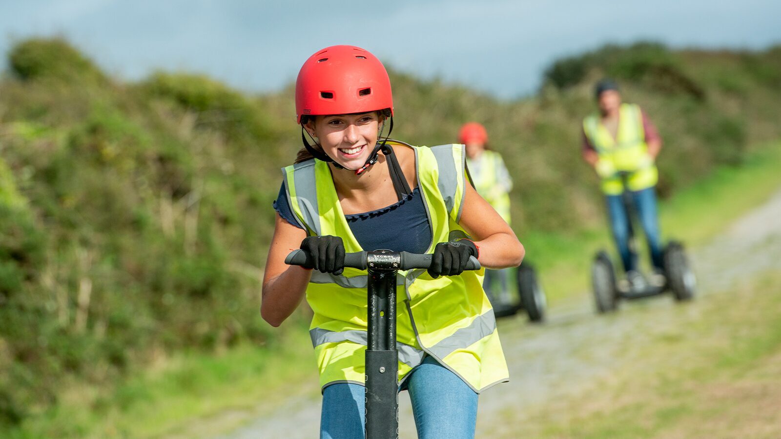 young girl wearing a red helmet riding a Segway at Woolacombe Bay Holiday Park in Devon