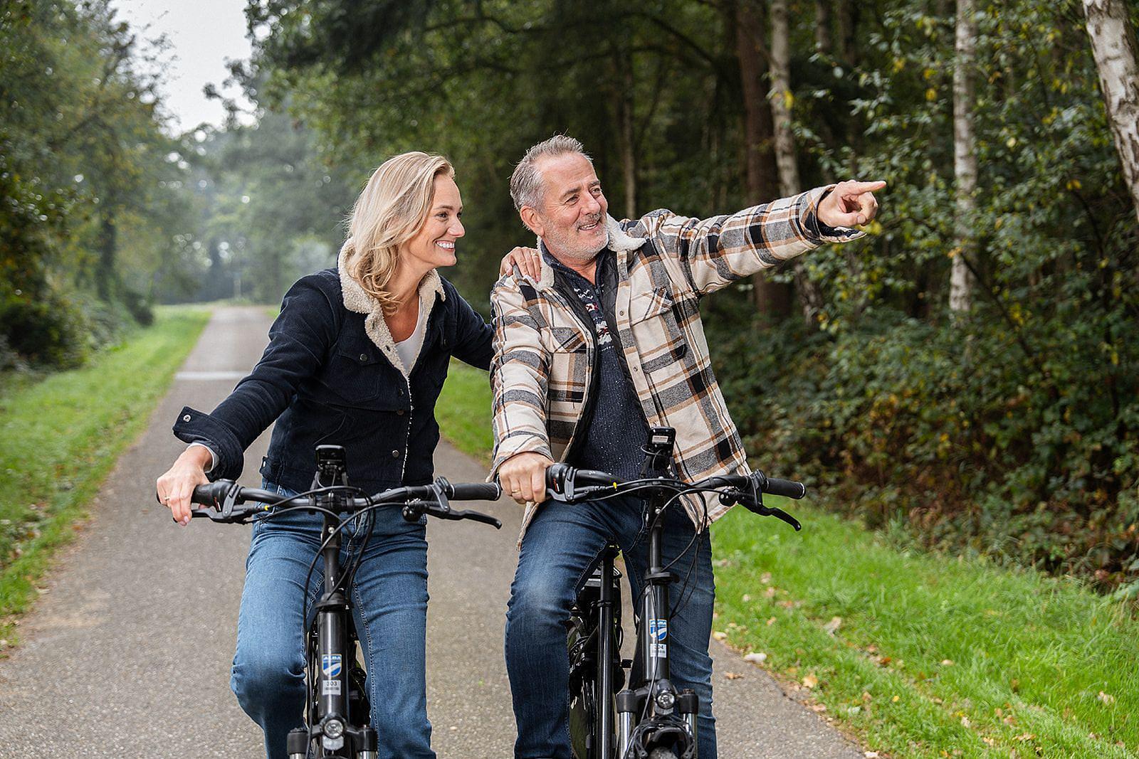 Ein Paar ist mit dem Fahrrad im Herbst unterwegs