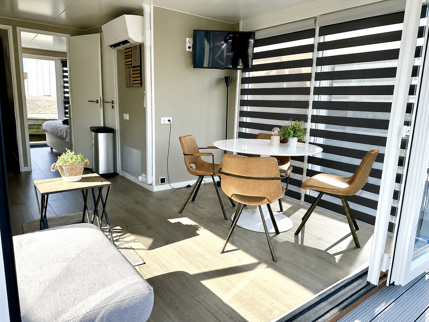 Modern dining and living area with views of the Veerse Meer