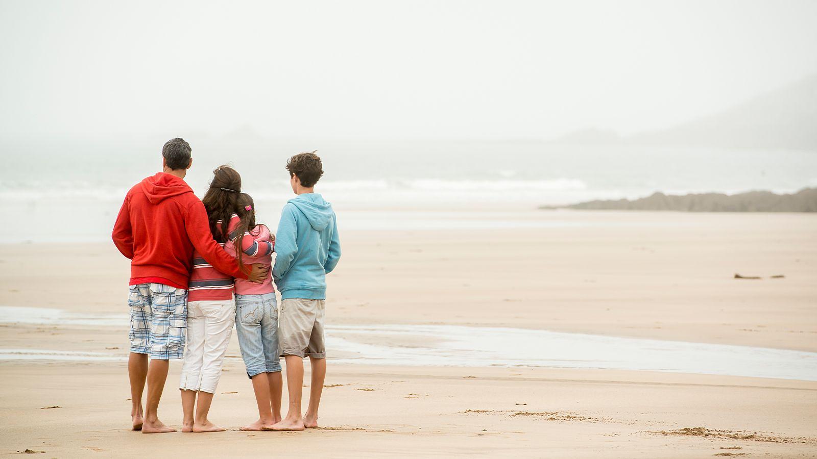 Family enjoying Woolacombe Beach on a cloudy day Family enjoying Woolacombe Beach on a cloudy day