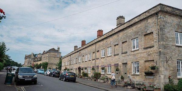 Historic streets and honey-coloured stone buildings in Cirencester, a market town in the Cotswolds