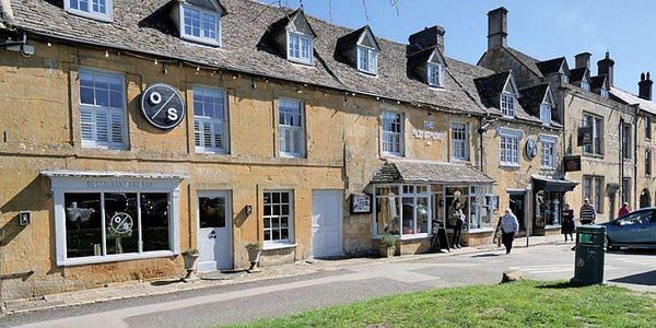 Historic stone buildings and independent shops along the high street in Stow-on-the-Wold, Cotswolds