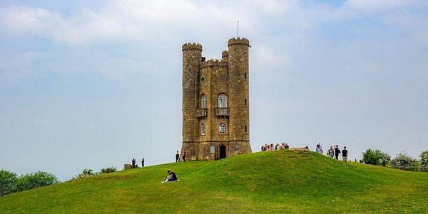 Broadway Tower standing atop a grassy hill overlooking the Cotswolds near Broadway