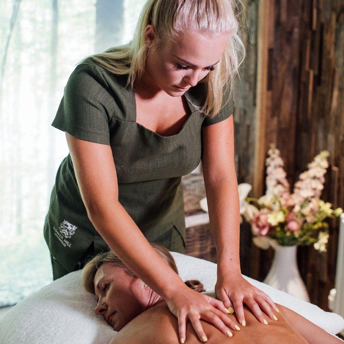 Spa therapist performing a back massage treatment at the Leisure & Wellness Club at Lower Mill Estate