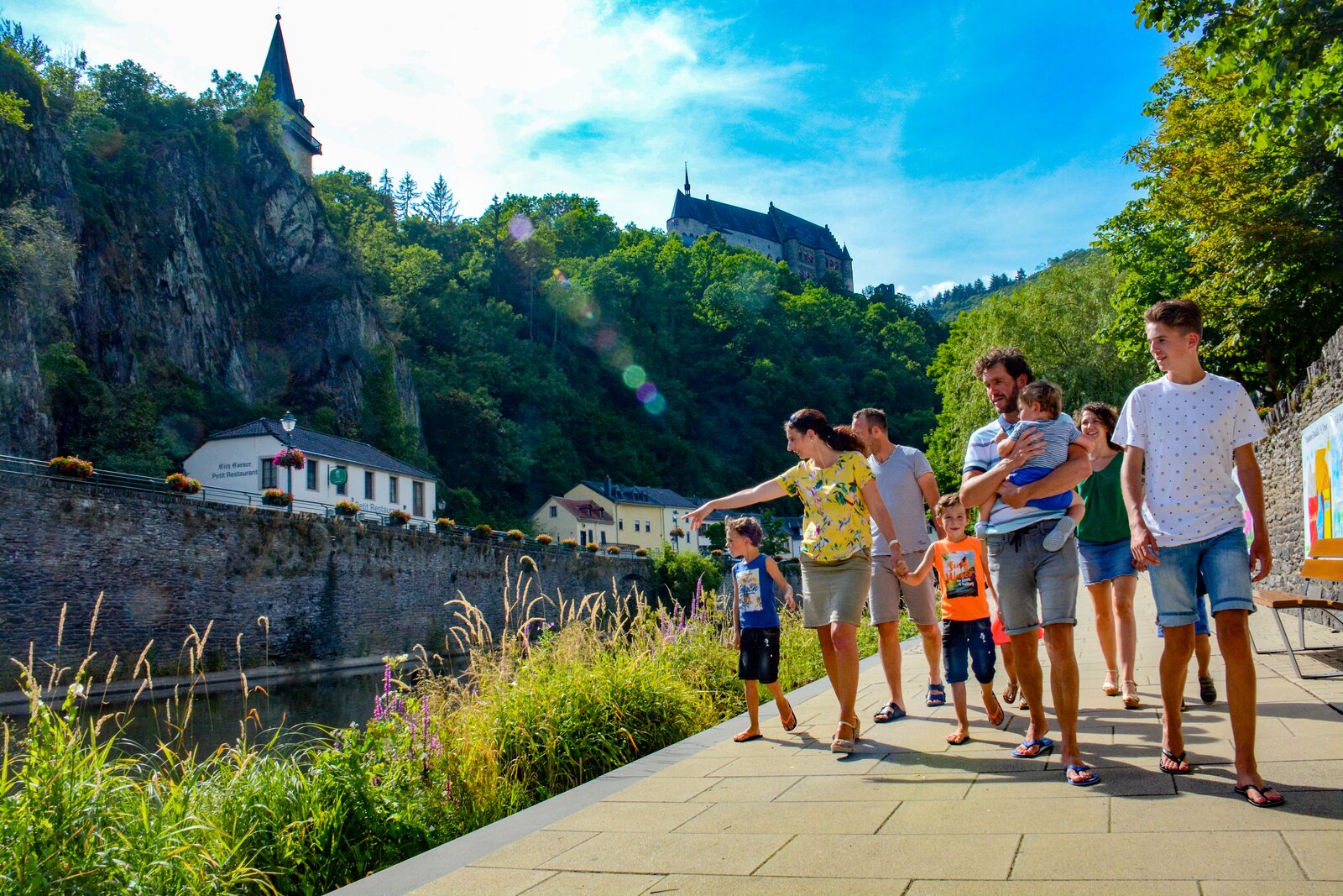 Family walking along water Vianden